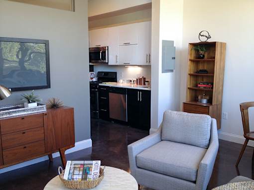 Open concept living space with kitchen and seating at 68 Beale Apartments, Quincy, MA 02169